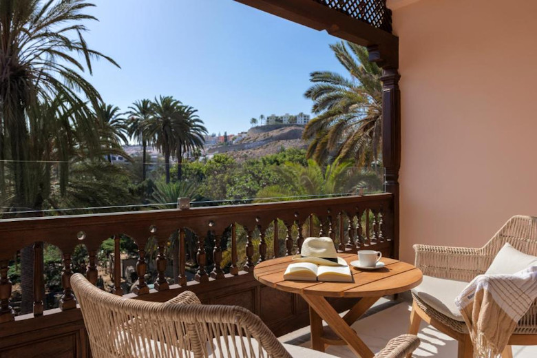 A balcony with garden views