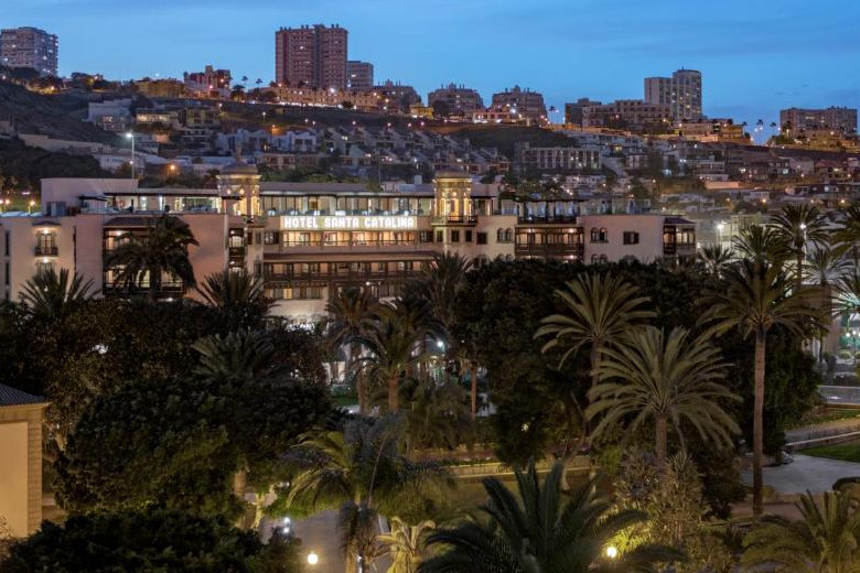 Night-time view of the hotel and the city