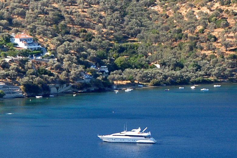 Villa Nafsika on the left, perched above the shore